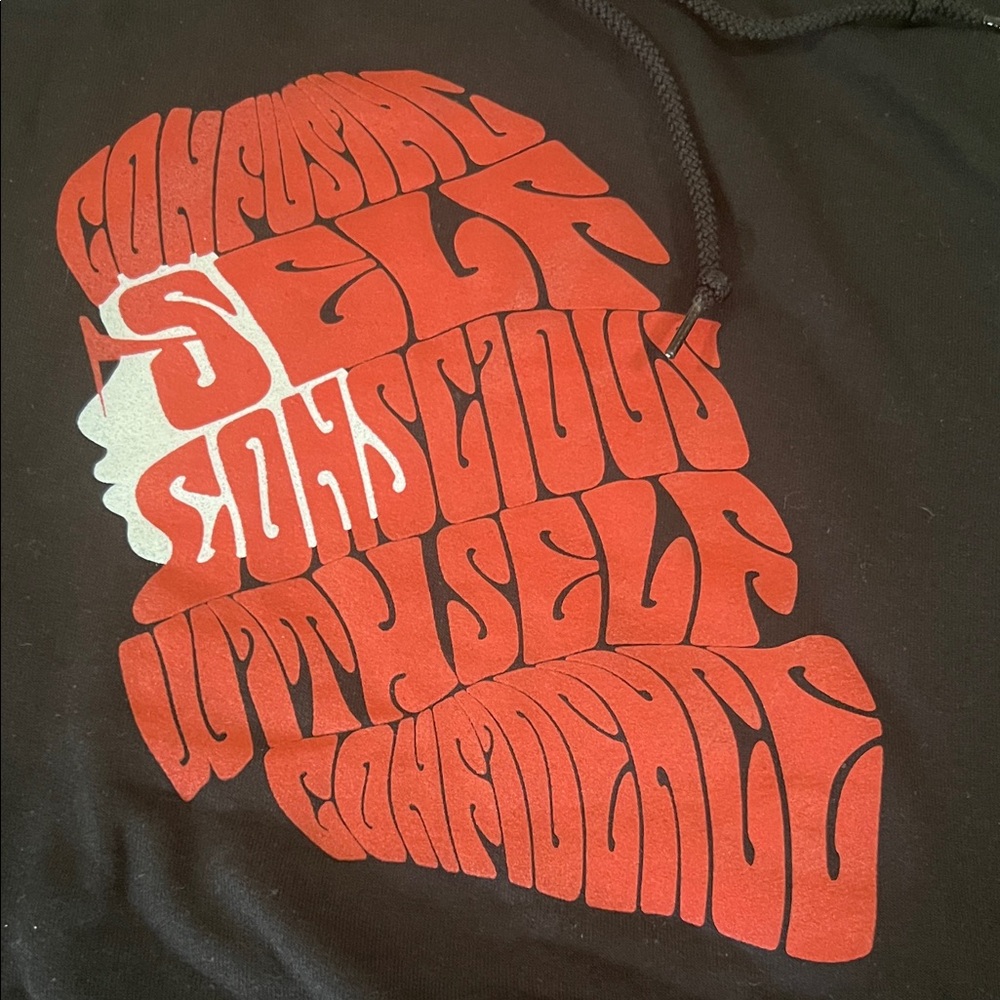Black and orange hoodie “ confusing self conscious with self confidence